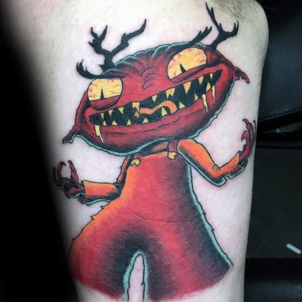 Tattoo of Evil Stewie from Family Guy with glowing yellow eyes, sharp teeth, and red overalls, featuring a sinister expression.