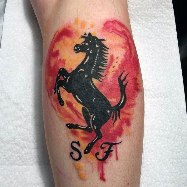 Bold Ferrari tattoo featuring a prancing black horse over a fiery red and orange watercolor background, with S F initials below.