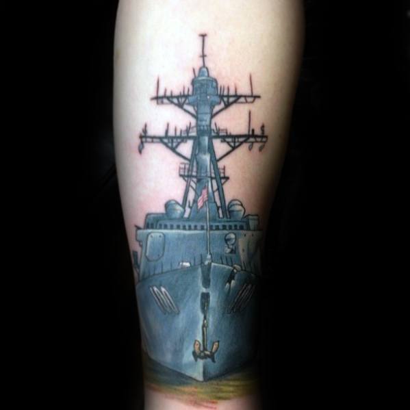 A grayscale battleship tattoo on a person's arm