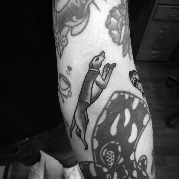 A sleek greyhound tattoo design in black ink, showcasing the graceful figure of the dog in motion.