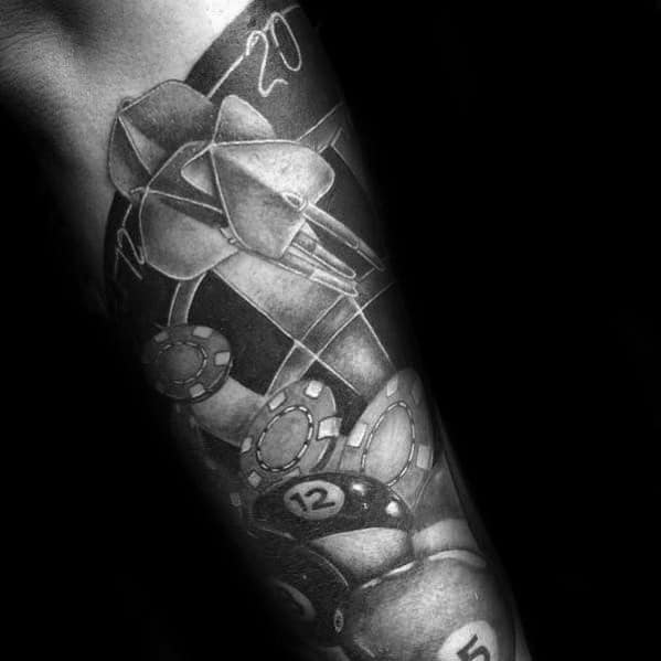 Tattoo sleeve featuring three darts on a dartboard with poker chips and billiard balls, blending themes of precision and luck.