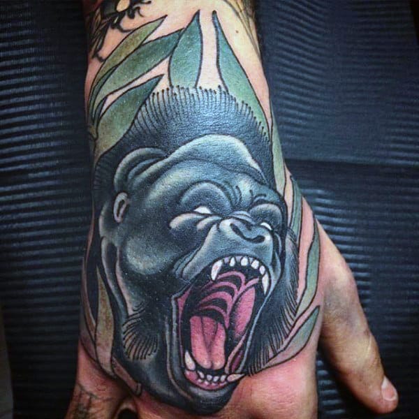 Amazing Mens Gorilla Hand Tattoo With Green Leaves