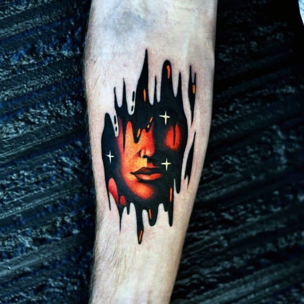 Gradient tattoo of a woman's face glowing in orange and red hues, melting through black ink with white star-like accents