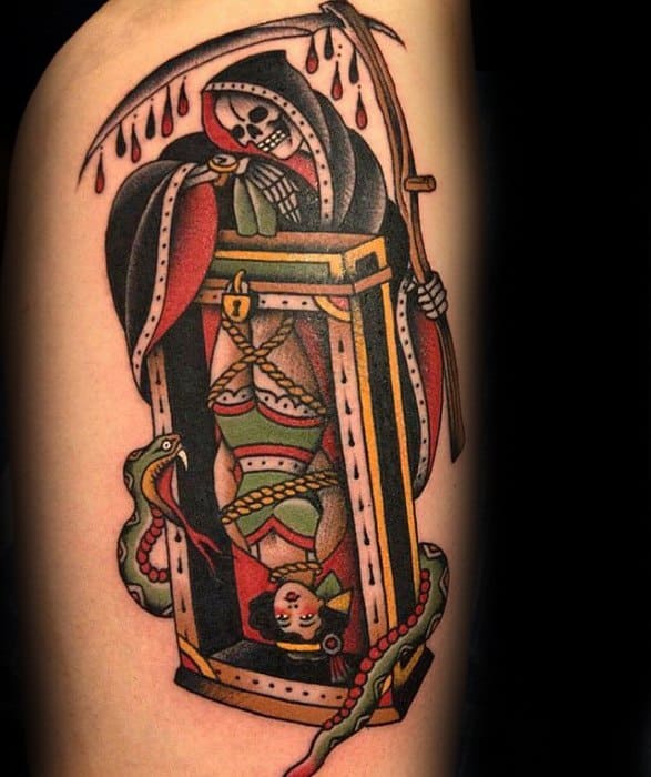 Tattoo of a hooded skeleton with a scythe next to a bound person in a box with snakes