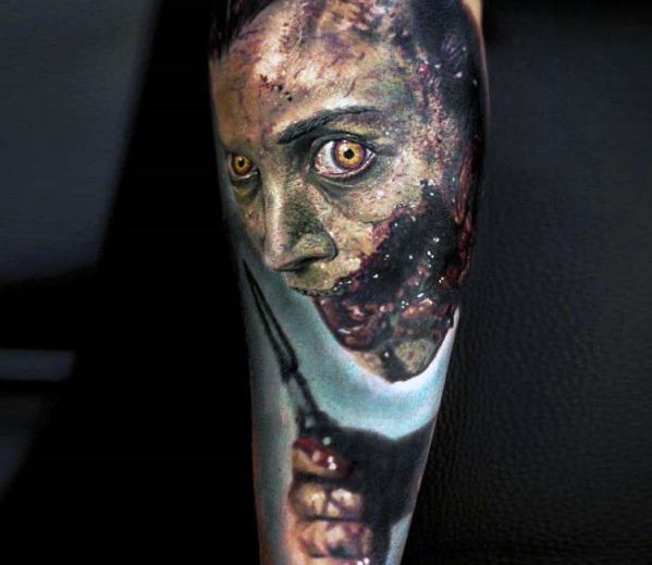 Realistic horror tattoo of a terrifying zombie-like figure with glowing yellow eyes, decayed flesh, and eerie shading for a gruesome and haunting effect.