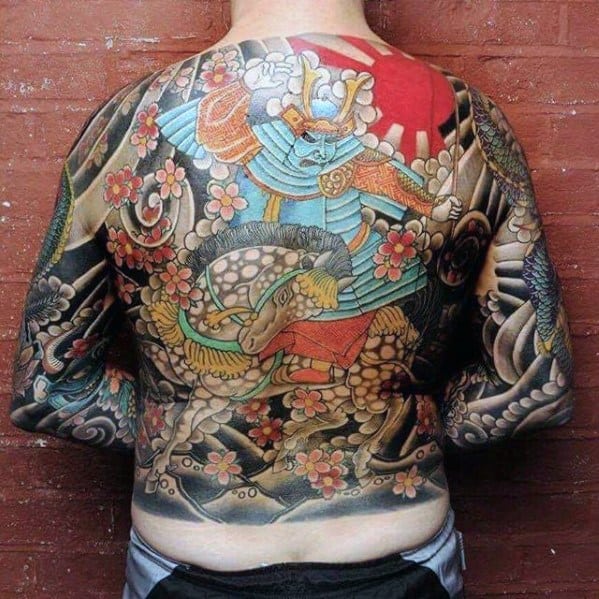Full back and sleeve Japanese-style tattoo of a warrior in vibrant armor riding a horse, surrounded by cherry blossoms and waves