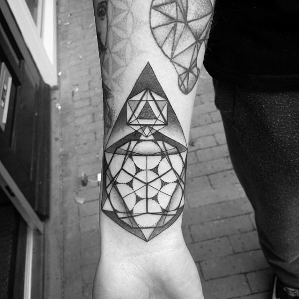 Icosahedron tattoo design on forearm featuring geometric patterns and intersecting shapes in bold black ink.