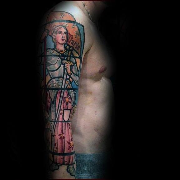 Joan of Arc full-sleeve tattoo for men featuring a stained glass style with bold colors and medieval warrior imagery.