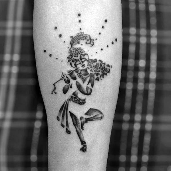 Krishna tattoo design showing Lord Krishna playing the flute with detailed ornaments and a dotted halo radiating around his head.