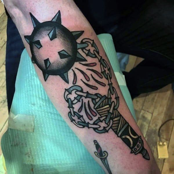 Mace tattoo with bold black ink, featuring a spiked ball on a chain connected to a decorated sword handle, symbolizing strength and power.