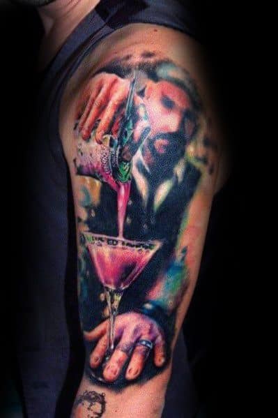 Bartender tattoo with a realistic martini glass, featuring a man pouring a pink cocktail. A vibrant, detailed design on the upper arm.