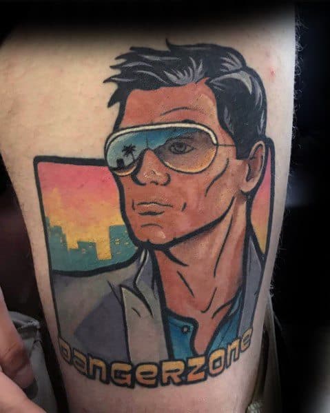Vibrant tattoo of Sterling Archer with aviators, Miami sunset backdrop, and 'Danger Zone' text, inspired by the animated series Archer.