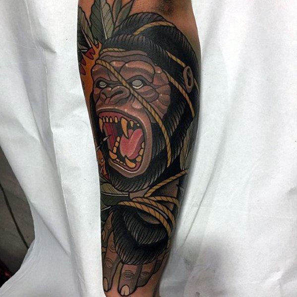Neo-traditional gorilla tattoo on forearm featuring bold lines, open mouth, rope details, and vibrant shading.