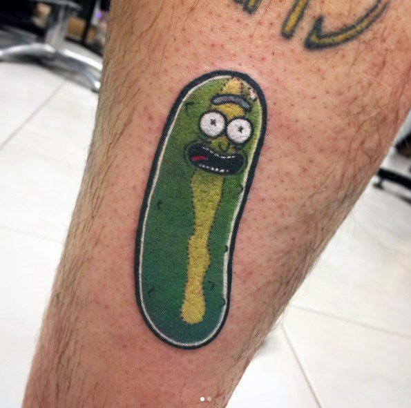 Minimalist Pickle Rick tattoo with a simple cartoon-style design, outlined in black with subtle shading on the lower leg.