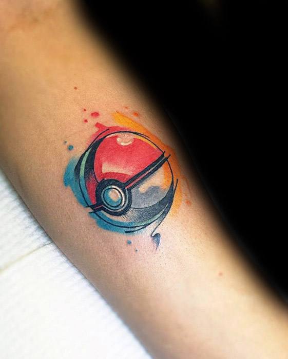 Colorful Pokeball tattoo on forearm with watercolor splashes in red, blue, and orange for a vibrant, artistic look.