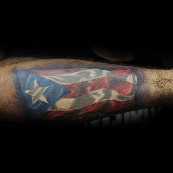 Puerto Rican flag tattoo on forearm with a realistic waving effect, showcasing vibrant red, white, and blue colors with a star.