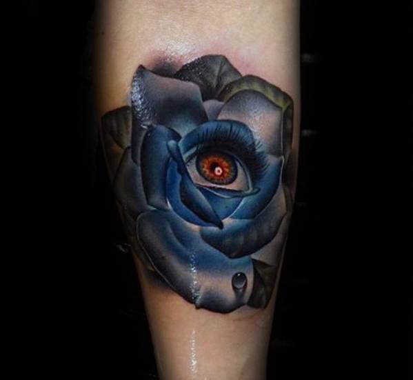 Surreal blue rose tattoo with a realistic red eye at the center, blending beauty and watchfulness in a striking design.