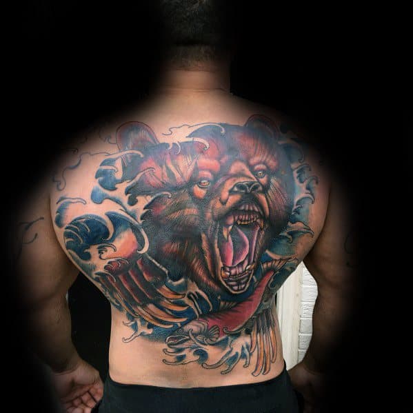 Ferocious bear tattoo with open jaws, surrounded by waves and claw marks, covering the entire back for a bold and powerful look.