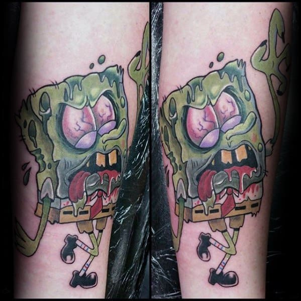 Zombie-style SpongeBob tattoo with green decayed skin, bulging eyes, and drooling mouth, capturing a creepy yet cartoonish look.