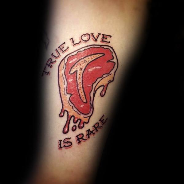 Steak tattoo with a rare cut design and dripping effect, featuring the phrase true love is rare in bold lettering around the image