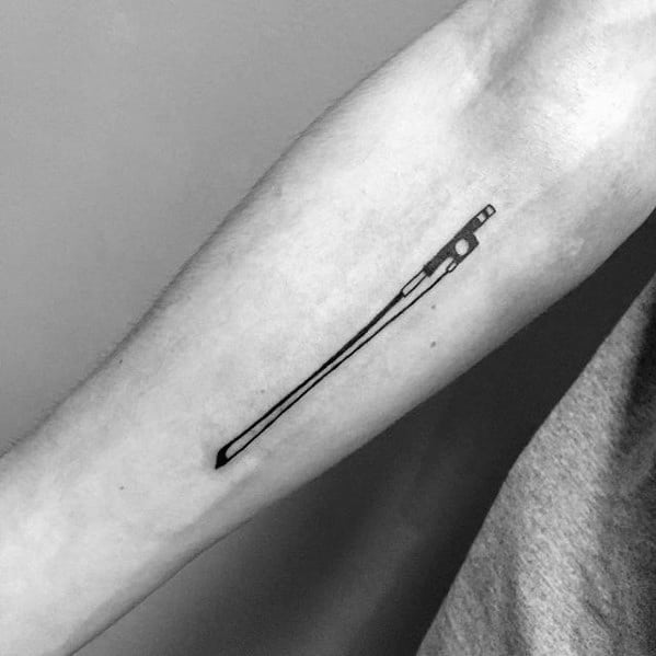 Minimalist tattoo of a violin bow inked on the inner forearm, featuring clean lines and simple black design for a subtle musical tribute.