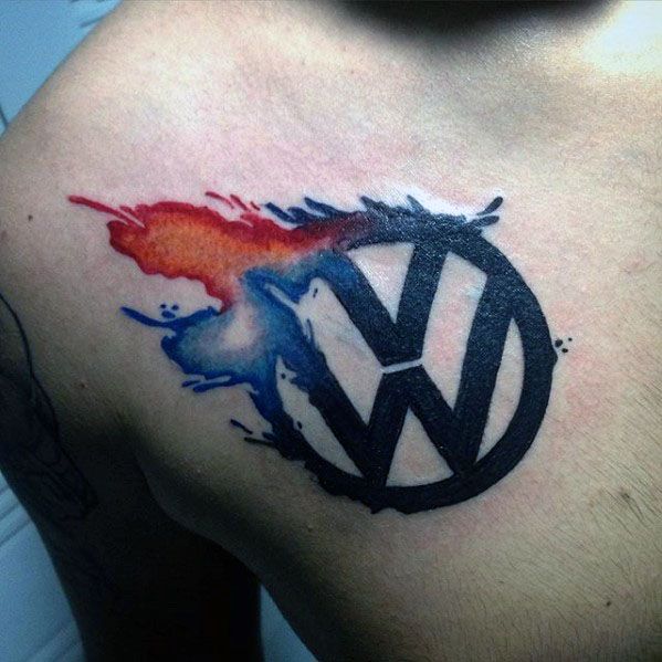 Volkswagen logo tattoo with black ink and watercolor-style red and blue splashes on the upper chest.