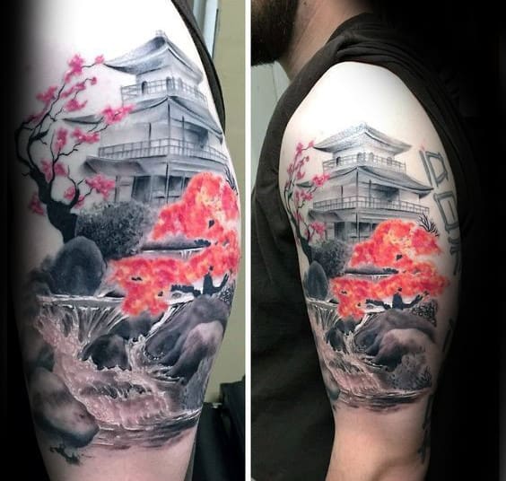 Realistic Japanese-themed upper arm tattoo featuring a pagoda, cherry blossoms, a flowing waterfall, and vibrant autumn foliage