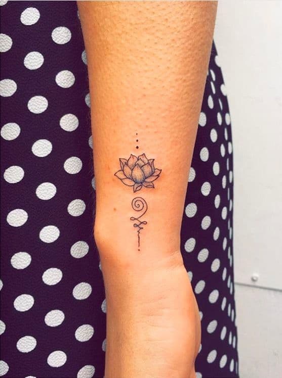 Unalome tattoo with a lotus on the wrist, symbolizing spiritual enlightenment, personal growth, and the journey toward inner peace.