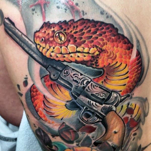 Amber Colored Chinese Dragon And Pistol Tattoo On Chest For Guys