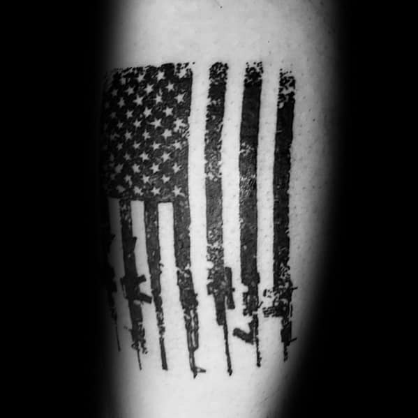 Black and grey American flag tattoo with AR-15 rifles forming the stripes, symbolizing patriotism, gun rights, and a dedication to the Second Amendment.