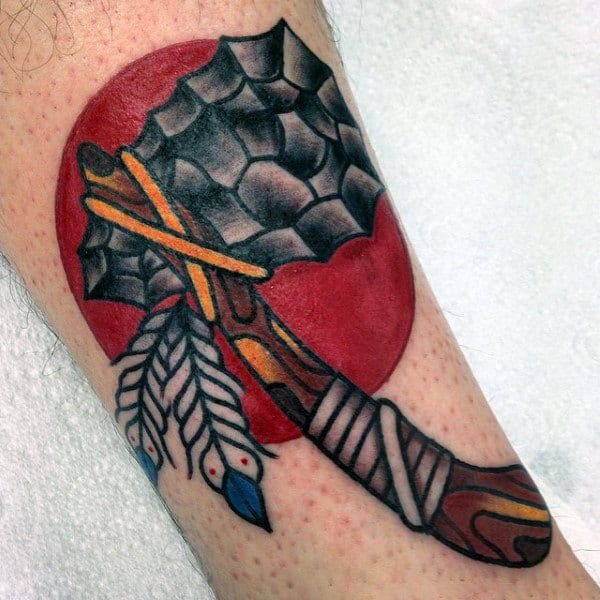 American Indian Tomahawk Tattoo With Red Rising Sun On Mans Arm