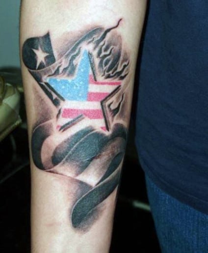 Forearm tattoo of a star with American flag colors and a ribbon around it