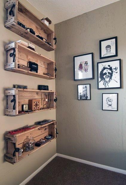 Corner wall with wooden crate shelves displaying decor items and framed black and white art pieces