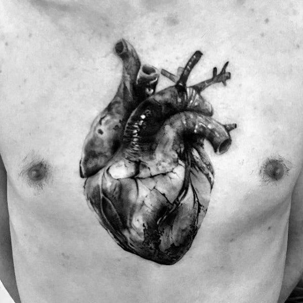 Black and grey 3D tattoo of an anatomical heart on the chest, featuring intricate shading and realistic vein details for a lifelike effect.