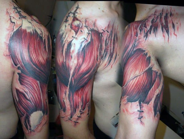 Anatomical muscle fiber tattoo on the upper arm and shoulder, designed to look like torn skin revealing red muscle tissue beneath.