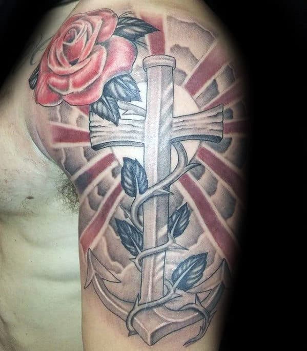 Tattoo of anchor wrapped in vines with a red rose on upper arm