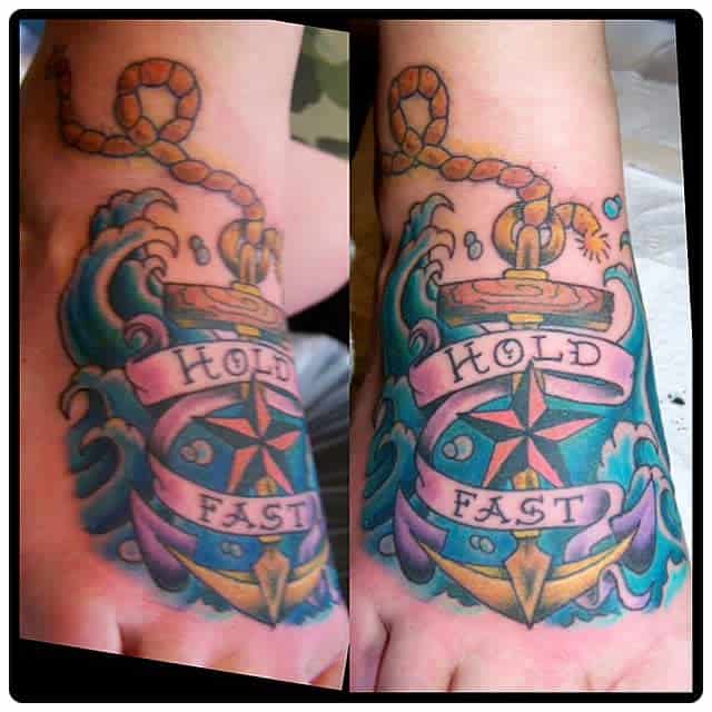 Colorful anchor tattoo with "Hold Fast" on a foot, surrounded by waves and a rope