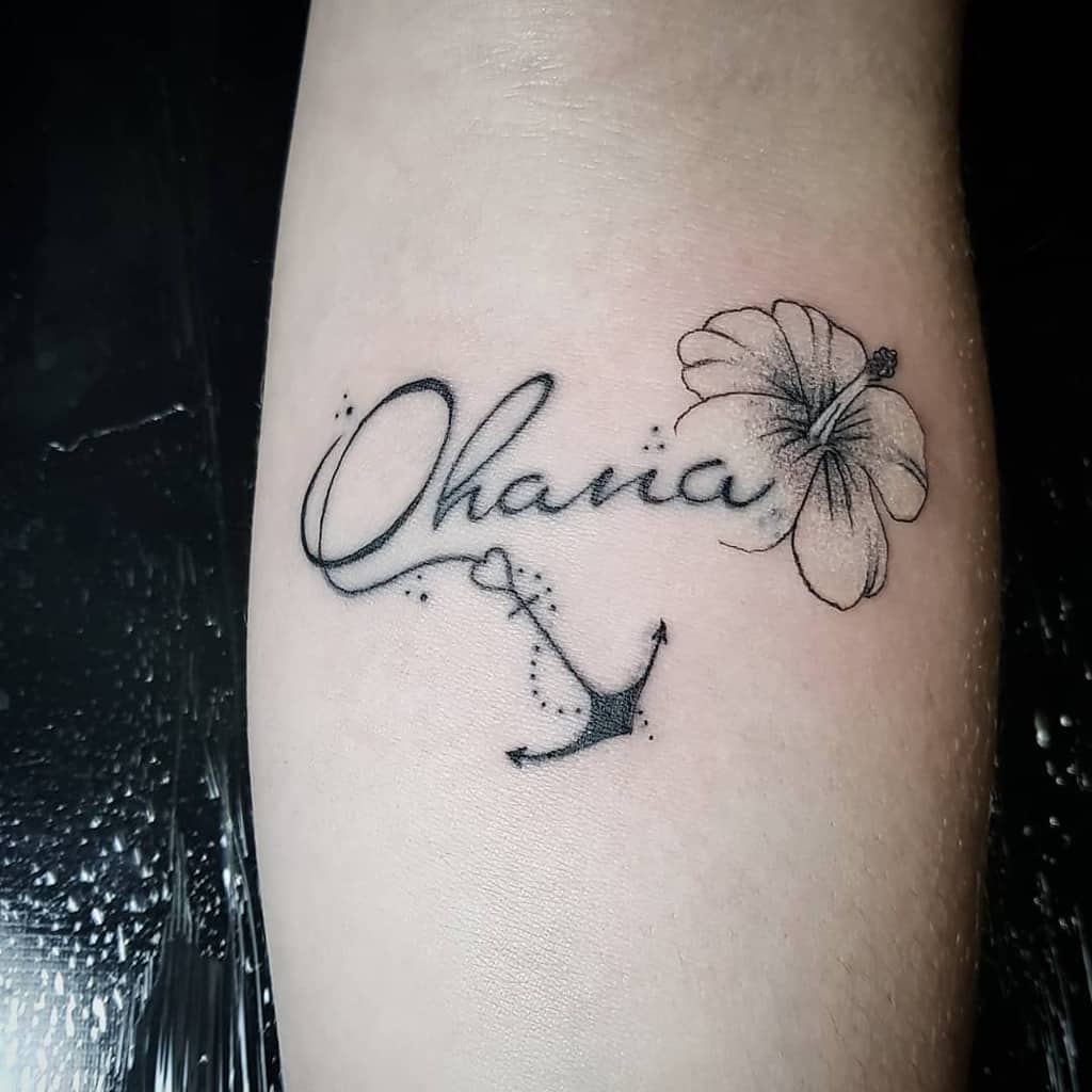 Elegant 'Ohana' tattoo with a hibiscus flower and anchor, symbolizing family, stability, and Hawaiian heritage.