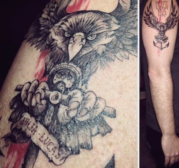 Arm tattoo of an eagle gripping an anchor with a ribbon 