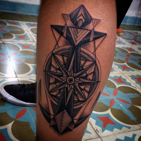 Geometric tattoo of a compass and anchor on a leg