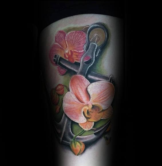 Tattoo of an anchor with orange orchids and green leaves