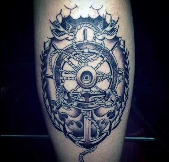 Tattoo of a ship's wheel, anchor, ropes, and laurel leaves on skin