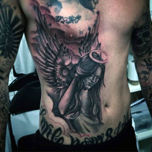 Tattoo of angel with wings and halo on a person's torso