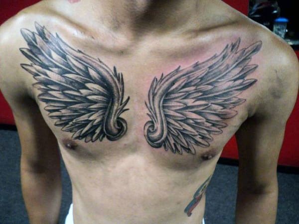 Chest tattoo of symmetrical, detailed angel wings
