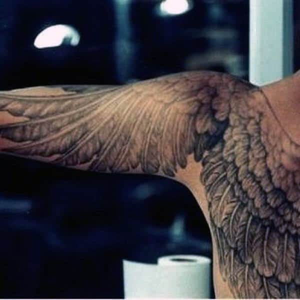 Wing tattoo covering a person's arm and shoulder