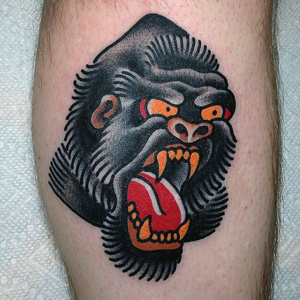 Angry Black Gorilla Tattoo With Red Tounge And Orange Eyes For Men On Calf