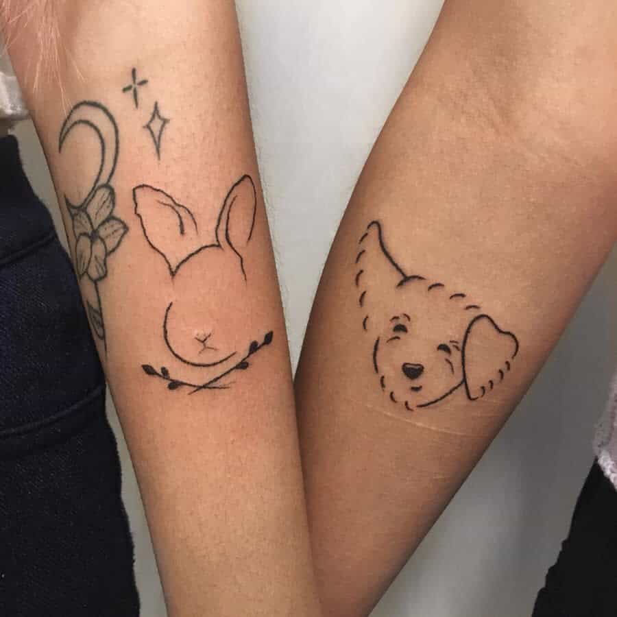 Matching tattoos featuring a minimalist bunny design on one arm and a simple winking dog outline on the other