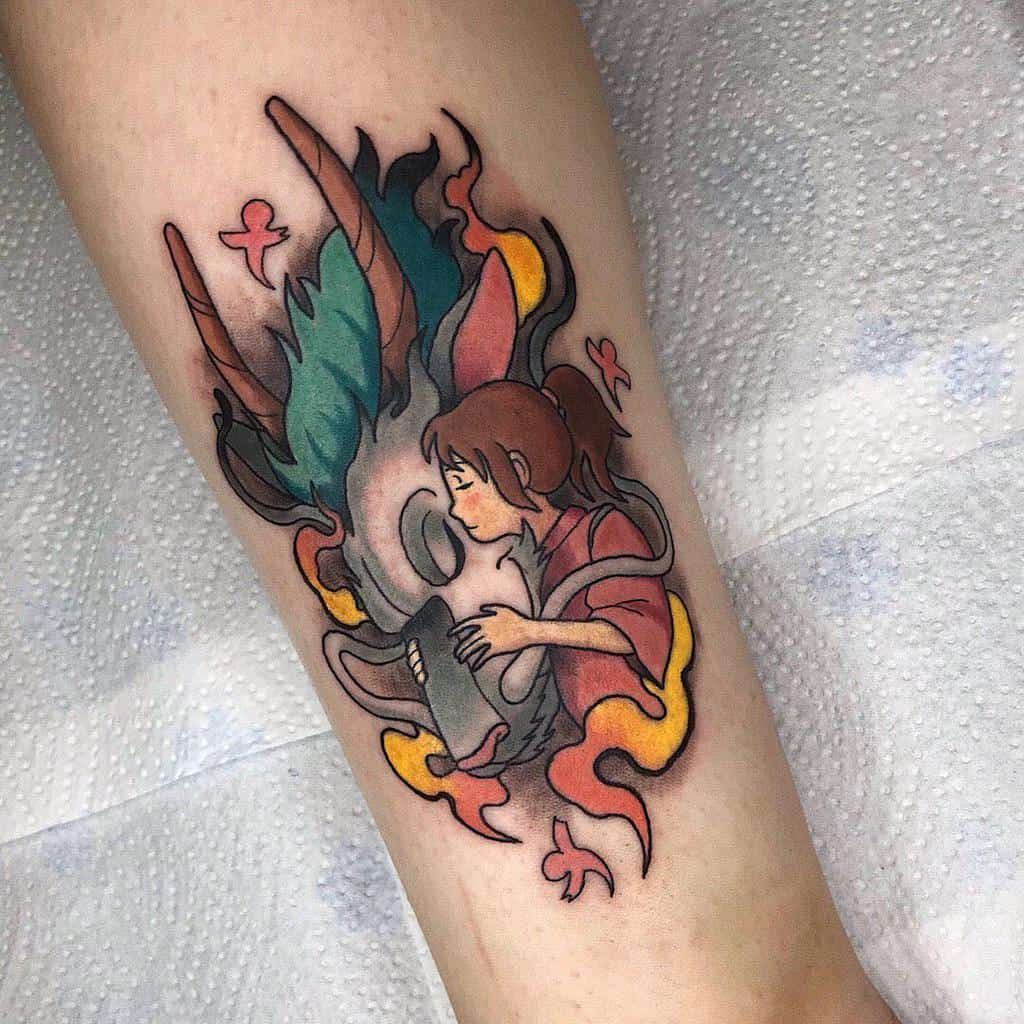 Vibrant tattoo of Chihiro and Haku from Spirited Away, depicting an emotional moment with paper birds and yellow smoke