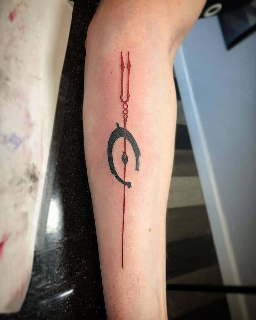 Minimalist Halo tattoo of the Didact's symbol with a red Forerunner-inspired design, inked on the forearm for a sleek, sci-fi look.