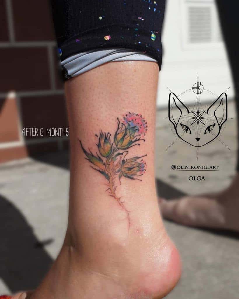 Tattoo of a vibrant thistle flower on an ankle